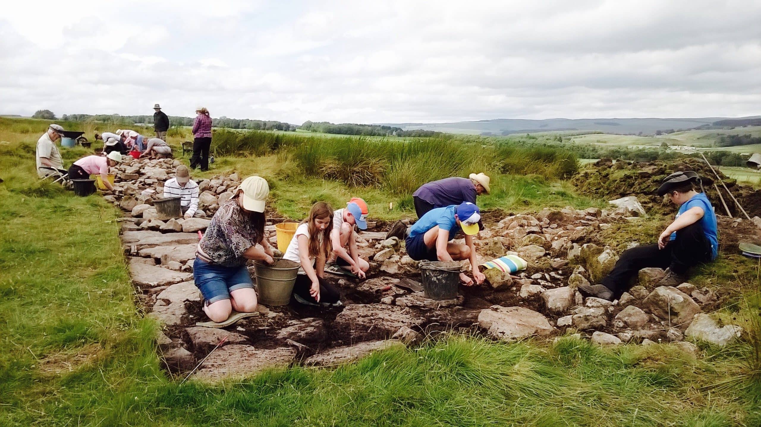 A group of young people conducting an archaeological excavation