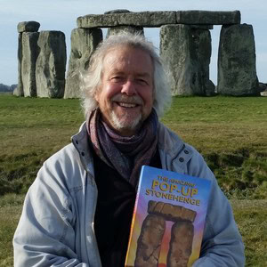 Archaeologist Julian Richards poses with the book 'The Amazing Pop-Up Stonehenge' in front of Stonehenge. 