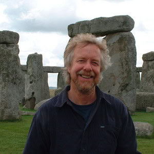 Archaeologist Julian Richards stands in front of Stonehenge.