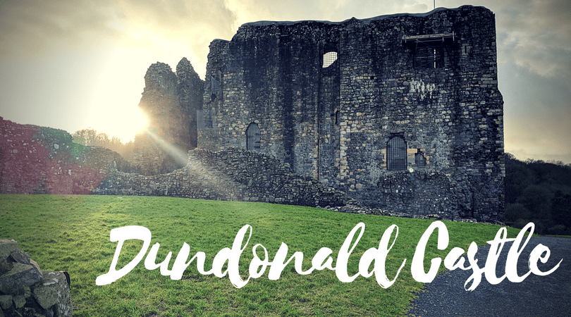 A stone castle with the words Dundonald Castle.
