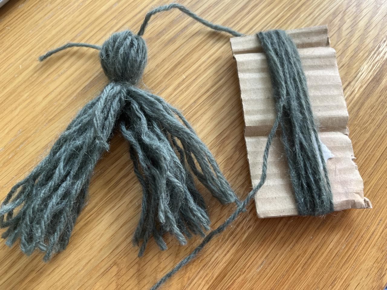 Dividing the yarn to create the doll's arms.