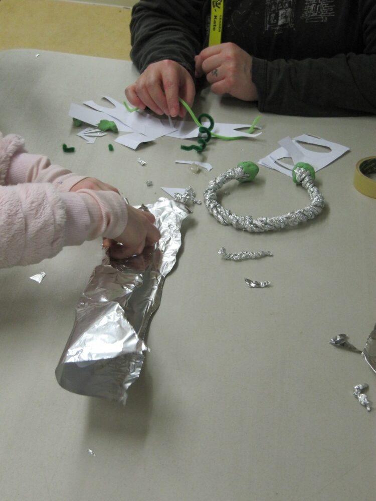 Young people crafting jewellery from foil.