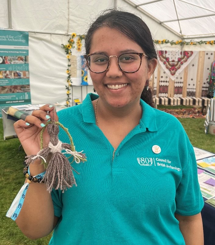 CBA employee Tejaswi holds her finished doll.