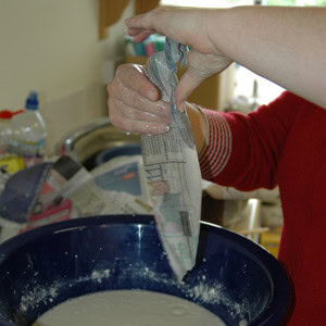 Dunking a newspaper slip into the petrosphere mixture.