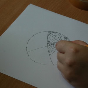 Designing the petrosphere pattern by drawing it on a piece of paper.