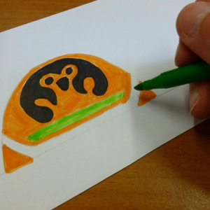 A drawing of the Egyptian god Qebehsenuef being coloured in.