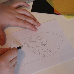 Sketching the window design onto a piece of paper.