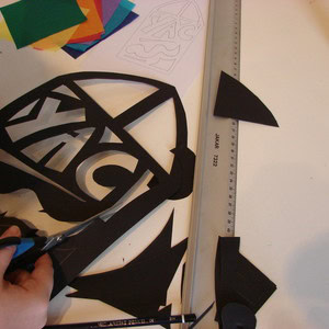 Cutting out the outline of the stained glass paper design.