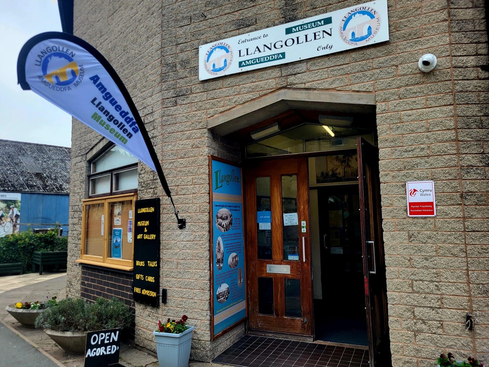 The entrance to a museum with a sign reading 'Llangollen Museum'