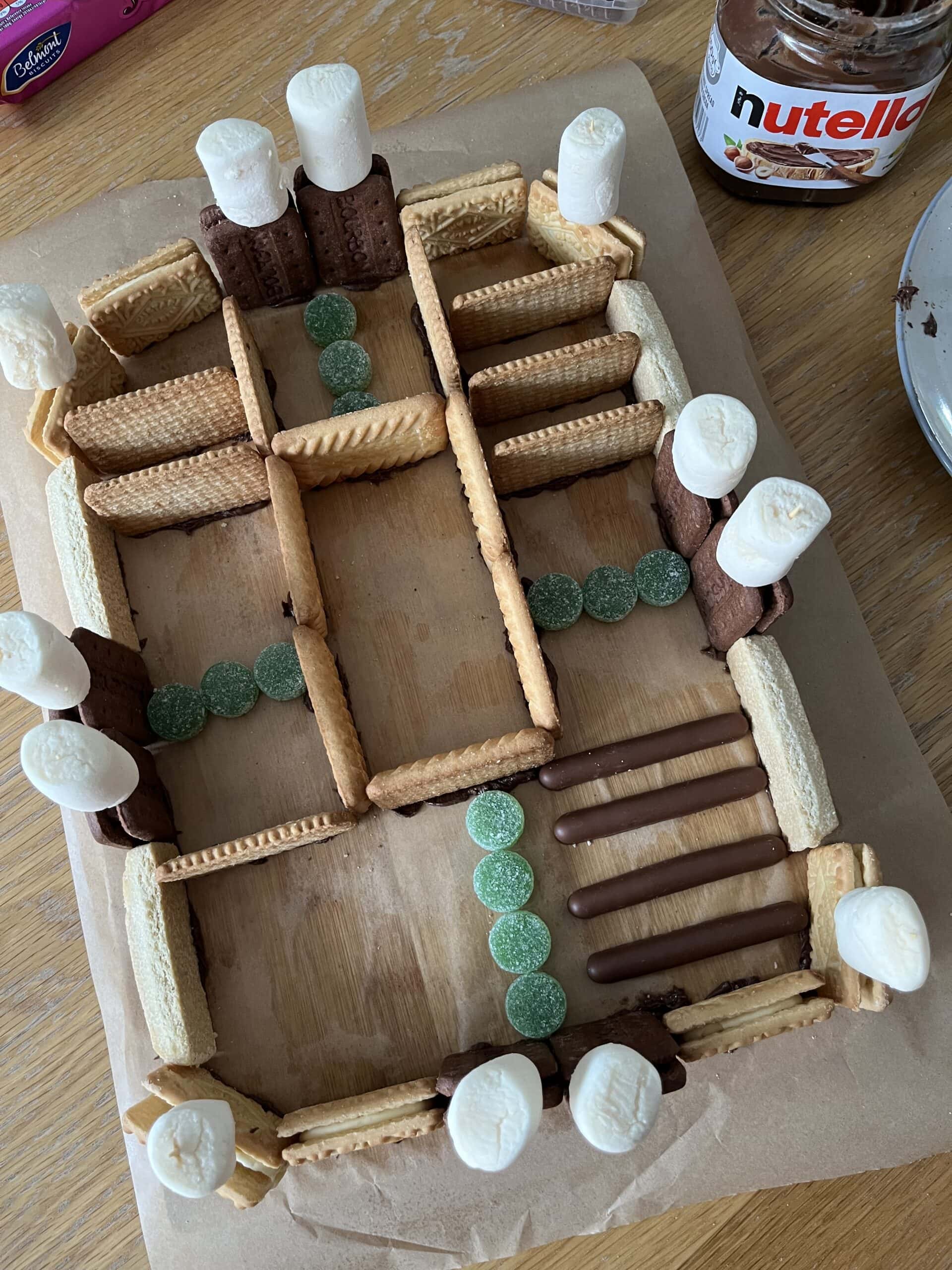 A rectangular structure made from biscuits and marshmallows representing an Roman fort