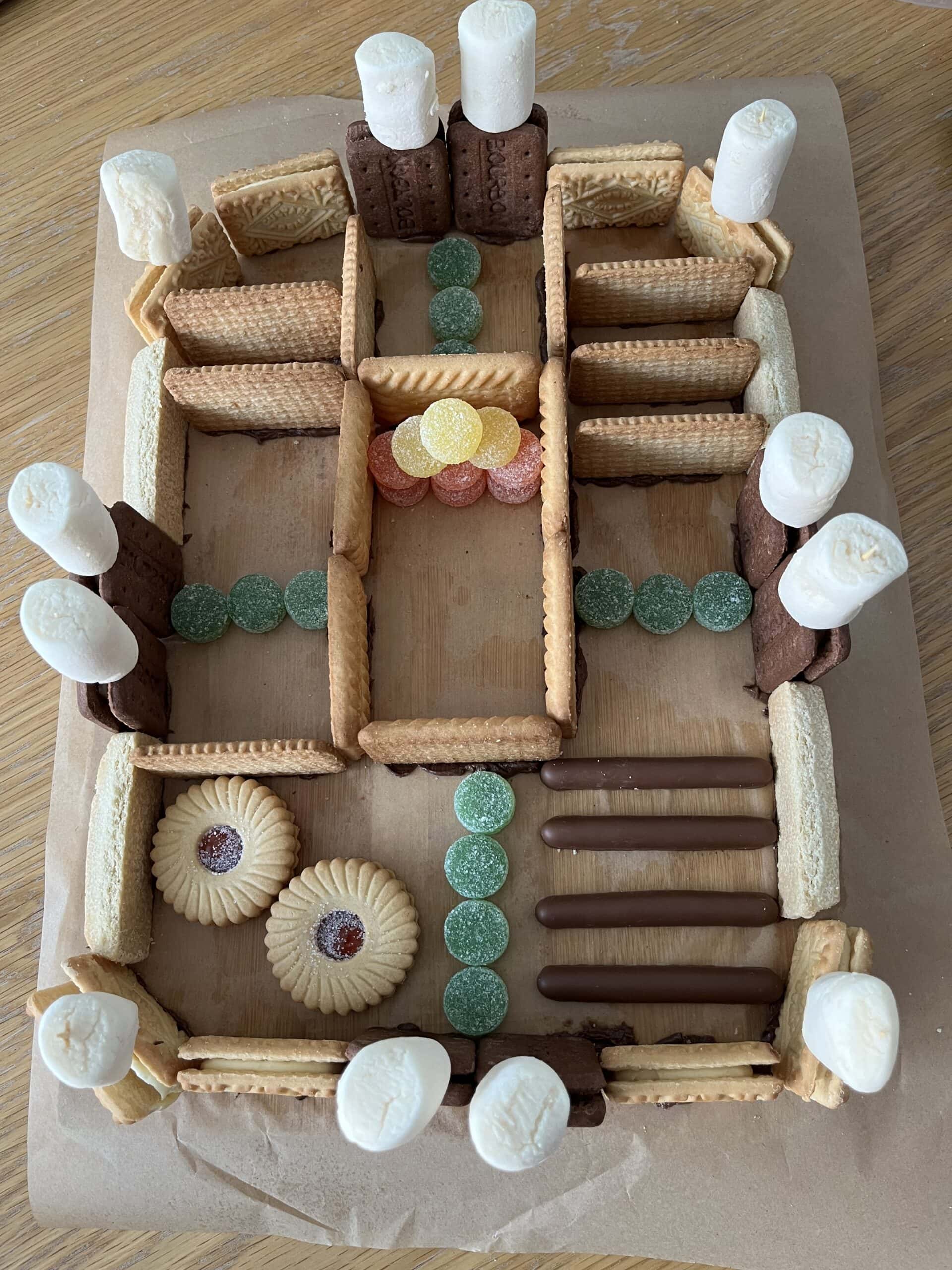 A rectangular structure made from biscuits and marshmallows representing an Roman fort
