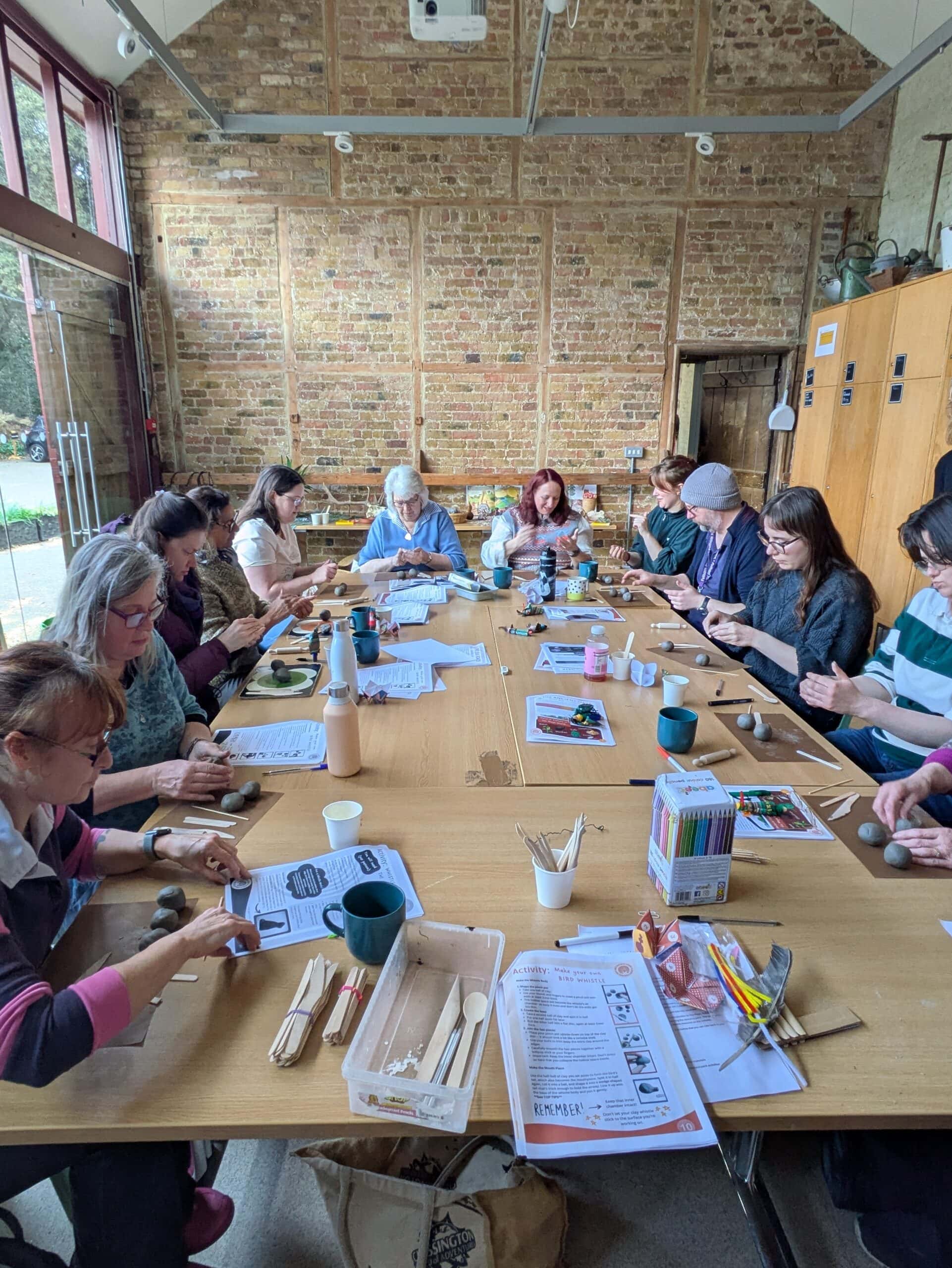 Group of YAC Leaders and Young Leaders undertaking training around a large wooden table