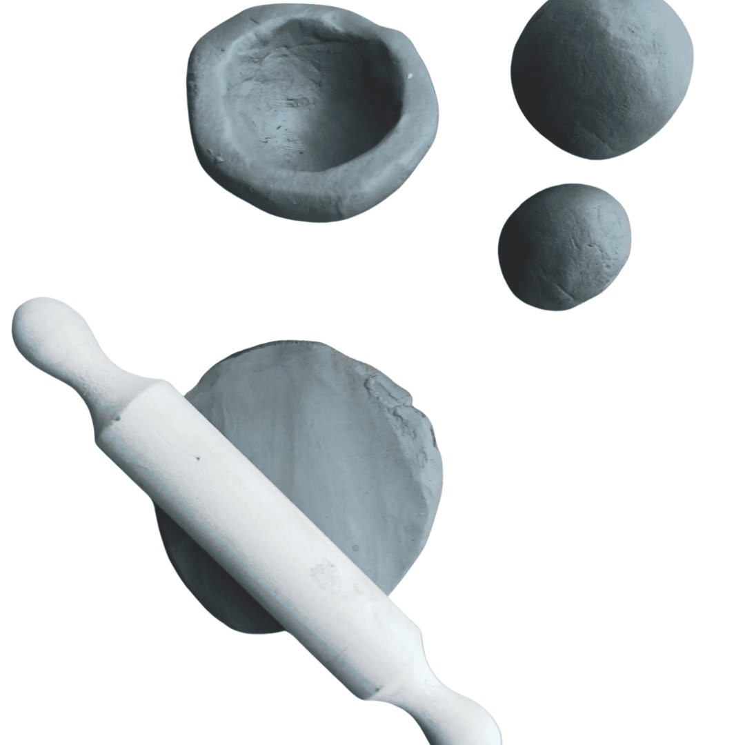 Two small balls of clay, a small bowl made from clay and a piece of clay flattened by a rolling pin.